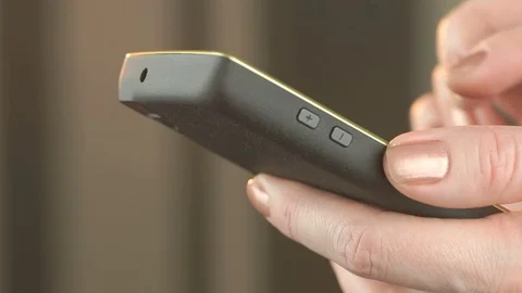 Woman texting to SMS using a smartphone. Close-up Stock Footage 70710324