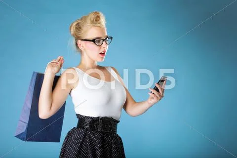 Woman texting while looking surprised on phone Stock Photos