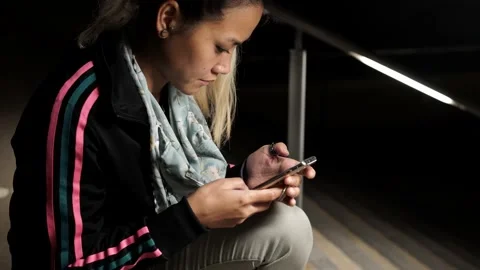 Woman Texting While Sitting on Subway Metro Stairs at Night Stock Footage 142341733