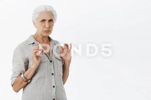 Woman think it disgusting. Portrait of displeased senior woman with white hair Stock Photos