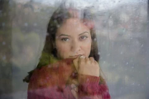 Woman, Thinking About Something While Looking Out The Window On A Rainy Day. 写真素材