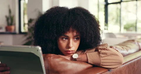 Woman, thinking and bored on sofa with tablet, tired and waiting for response on Stock Footage 312800607