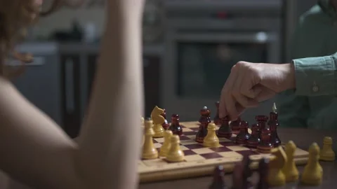 Woman thinking before making a chess move. Board game Stockbeeldmateriaal 148339558