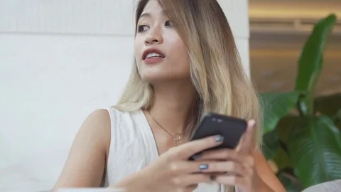 Woman is thinking what to write in an answer to boyfriend on smartphone app Stock Footage 79296785