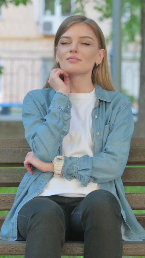 Woman Thinking while Sitting on Bench in Park, Vertical Video Stock Footage 319006070