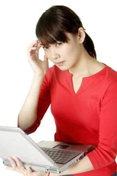 Woman thinking while using laptop Stock Photos