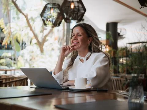 Woman thinking while using laptop Stock Photos