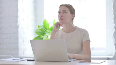 Woman Thinking while Working on Laptop Stock Footage 204999932