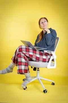 Woman thinking while working remotely in comfortable pajamas 스톡 사진