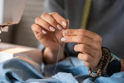 Woman Threading A Needle Stock Photos