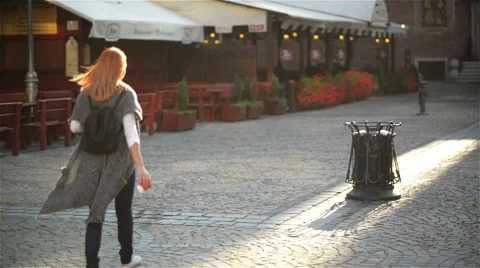 Woman throwing empty paper coffee cup near recycling bin, city background Stock Footage 67806566