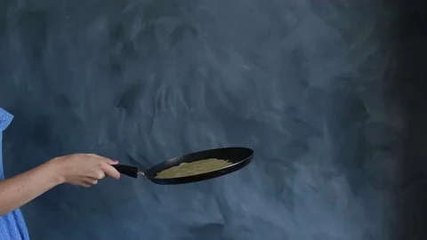 Woman throwing a pancake on a baking pan Video stock 79028092