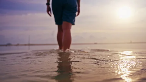 Woman Throwing Plastic Bottle into Shallow Sea at Sunset, Irresponsible Behavior Stock Footage 329060650
