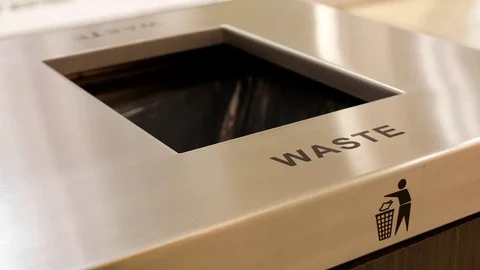 Woman throwing trash to the garbage can inside shopping mall Stock Footage 72423508