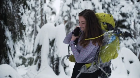 Woman throws on backpack to start her hike Stock Footage 86002846