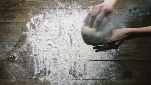 Woman throws dough onto table surface with flour slow motion Stock-Footage 120167384