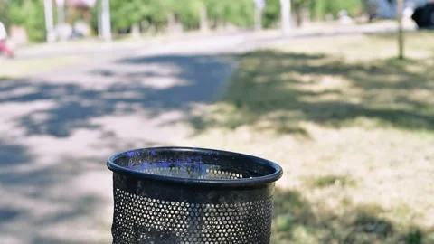 A woman throws an empty paper cup of coffee in the trash Stock Footage 280554164