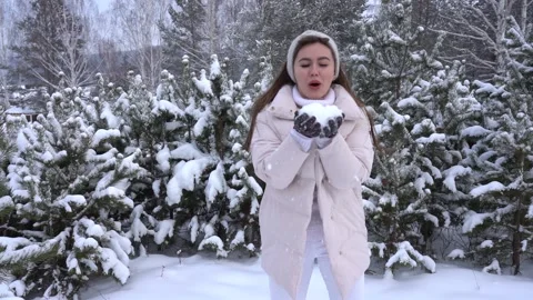 Woman throws snow Stock Footage 157536631