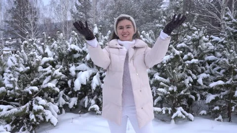 Woman throws snow Stock Footage 165992660
