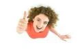 The woman thumbs up to the camera. View from above Photo