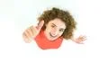 The woman thumbs up to the camera. View from above Photo