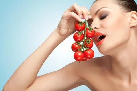 Woman with tomatoes. Stock Photos
