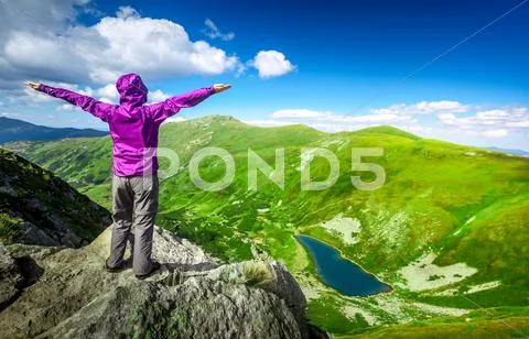 Woman on top of a mountain Stock Photos