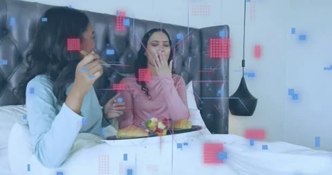 Woman touching fruit fork and feeding partner breakfast while digital overlay Stock Footage 320486736