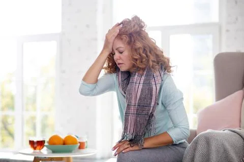 Woman touching her forehead while feeling dizzy having flu Stock Photos