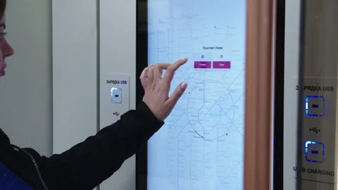 Woman is touching the interactive metro map and choosing the station Stock Footage 202049598