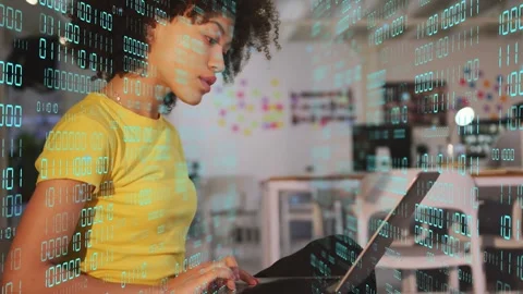 Woman touching lips while typing on laptop and showing binary overlay over Stock Footage 333873278