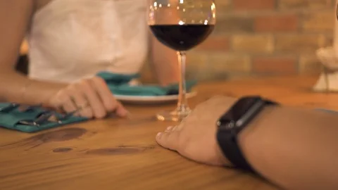 Woman touching man hand while romantic dinner in evening restaurant. Female hand Video stock 103839963