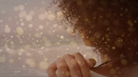 Woman touching shoulder as camera pulling back, revealing profile, golden bokeh Video stock 335465278