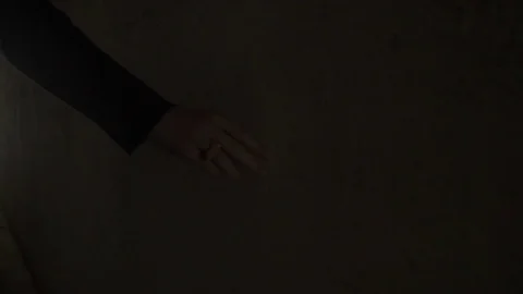 Woman touching a wall while walking in corridor 스톡 동영상 72507761