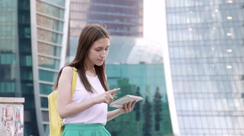 Woman in town using electronic tablet Stock Footage 52328311