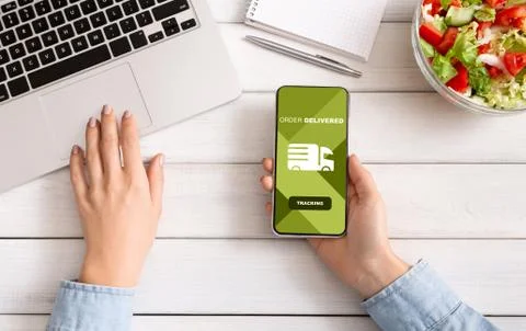 Woman tracking an order using cell phone Fotos Stock