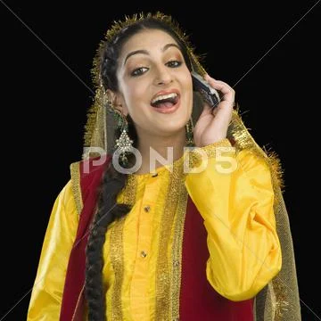 Woman in traditional Punjabi dress using a mobile phone Stock Photos