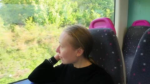 Woman on a train looking at the window Foto stock