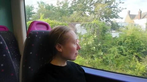 Woman on a train looking at the window Foto stock