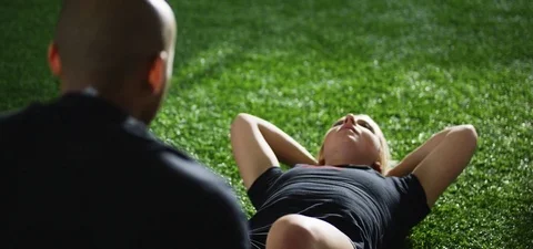 Woman with trainer doing sit ups in fitness studio 動画素材 77322584