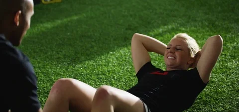 Woman with trainer doing sit ups in fitness studio Stock-Footage 77322869