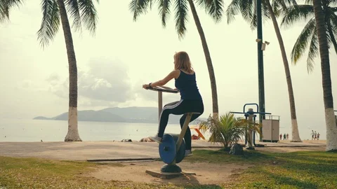 Woman is training at theseashore using simulator. Stock Footage 120768553
