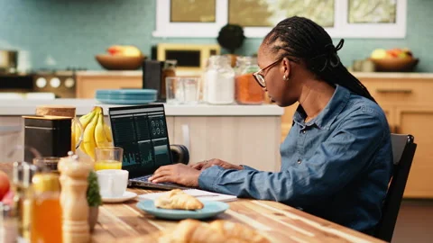 Woman transcribing data for research using laptop and digital tools Stock Footage 344247181