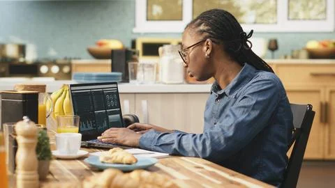 Woman transcribing data for research using laptop and digital tools Stock Photos