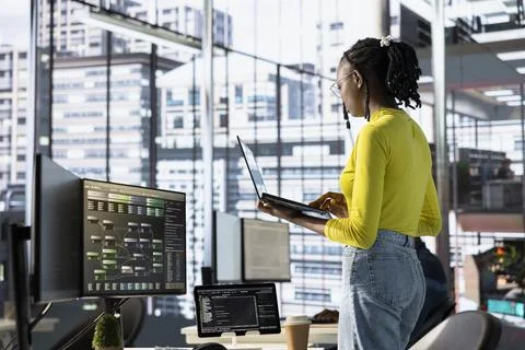 Woman transforming data into predictive models using notebook in office Fotos de archivo