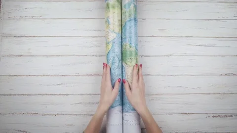 Woman traveler opens the map on the table and looks for a way to travel. Top Stock Footage 84893823