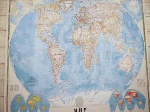 A woman traveler opens a map on the table and places flags in the cities of Stock Footage 84896658