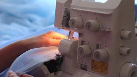 Woman treated tissue using overlock. Cuts the fabric edge. Women's hands Video stock 67229570