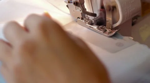 Woman treated tissue using overlock. Overlock foot closeup. Women's hands Video stock 67229693
