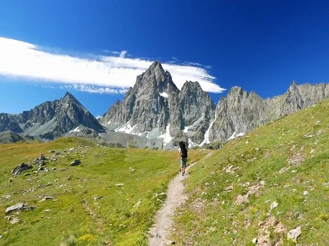 Woman trekking in idyllic mountain landscape Stock Footage